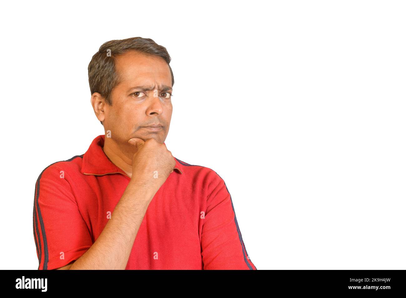Studio portrait of a man with a worried look against a white isolated background Stock Photo