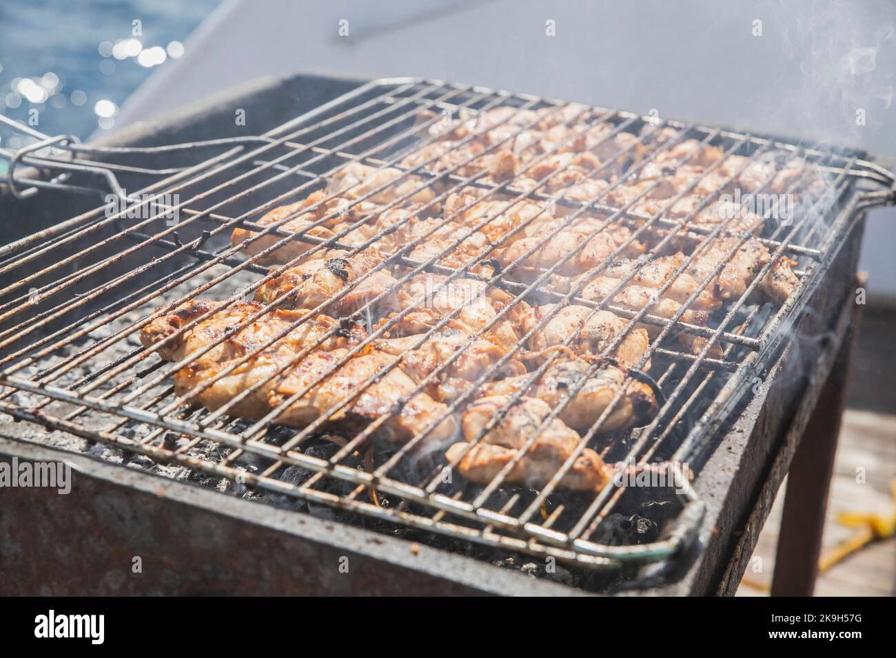 appetizing meat is frying on the grill on a yacht  Stock Photo