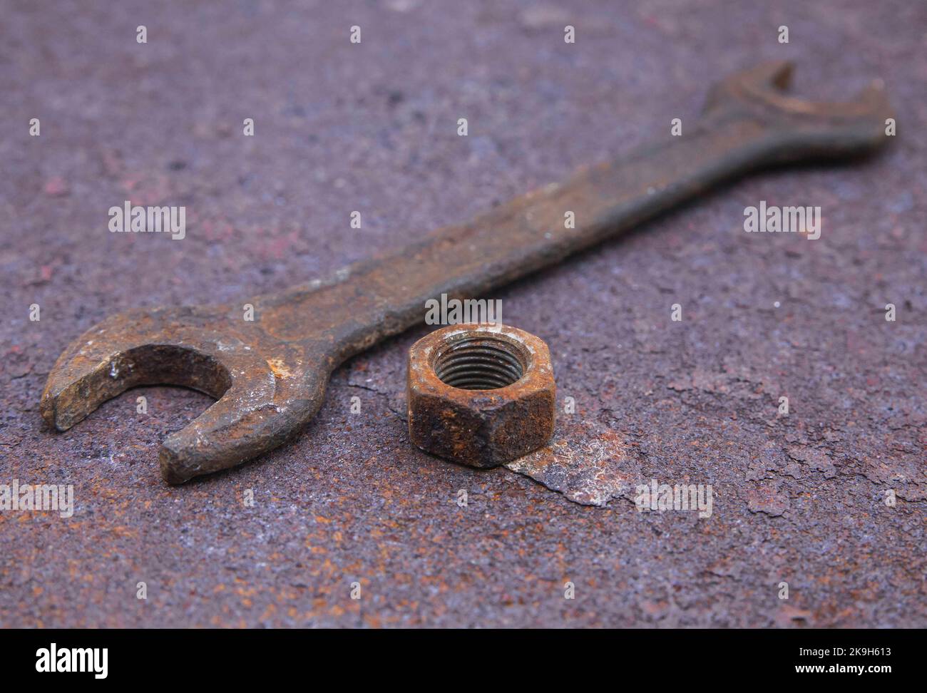 Old wrench and nut on a rusty countertop Stock Photo Alamy