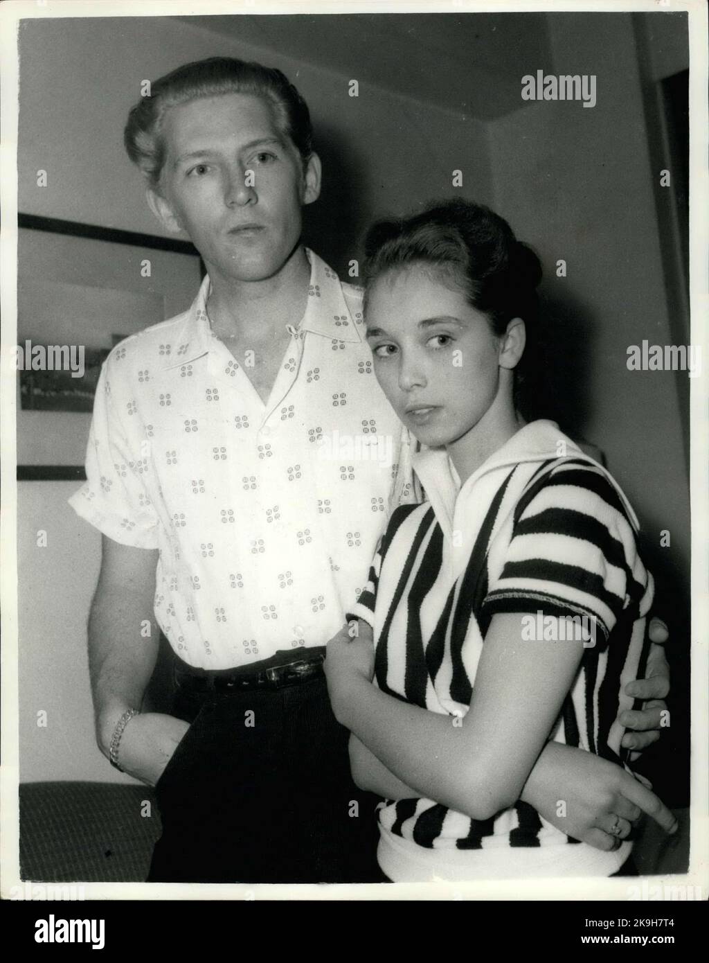 May 23, 1958 - 22 - year - old American rock n' roll singer arrives here with his 15 - year old wife: Jerry Lee Lewis, the American rock n' roll singer, flew into London yesterday with a shock for his fans. For the girl who arrived with him turned out to be his 15 - year - old wife of two months. Her name was Myra, and she is his third wife. Jerry was first married at 15 and again at 17, but this time he says he has found the right girl.When asked if she thought that fifteen was too young to be a wife, Myra explained that back at her home town Memphis, Tennessee, you can marry at the age of te Stock Photo