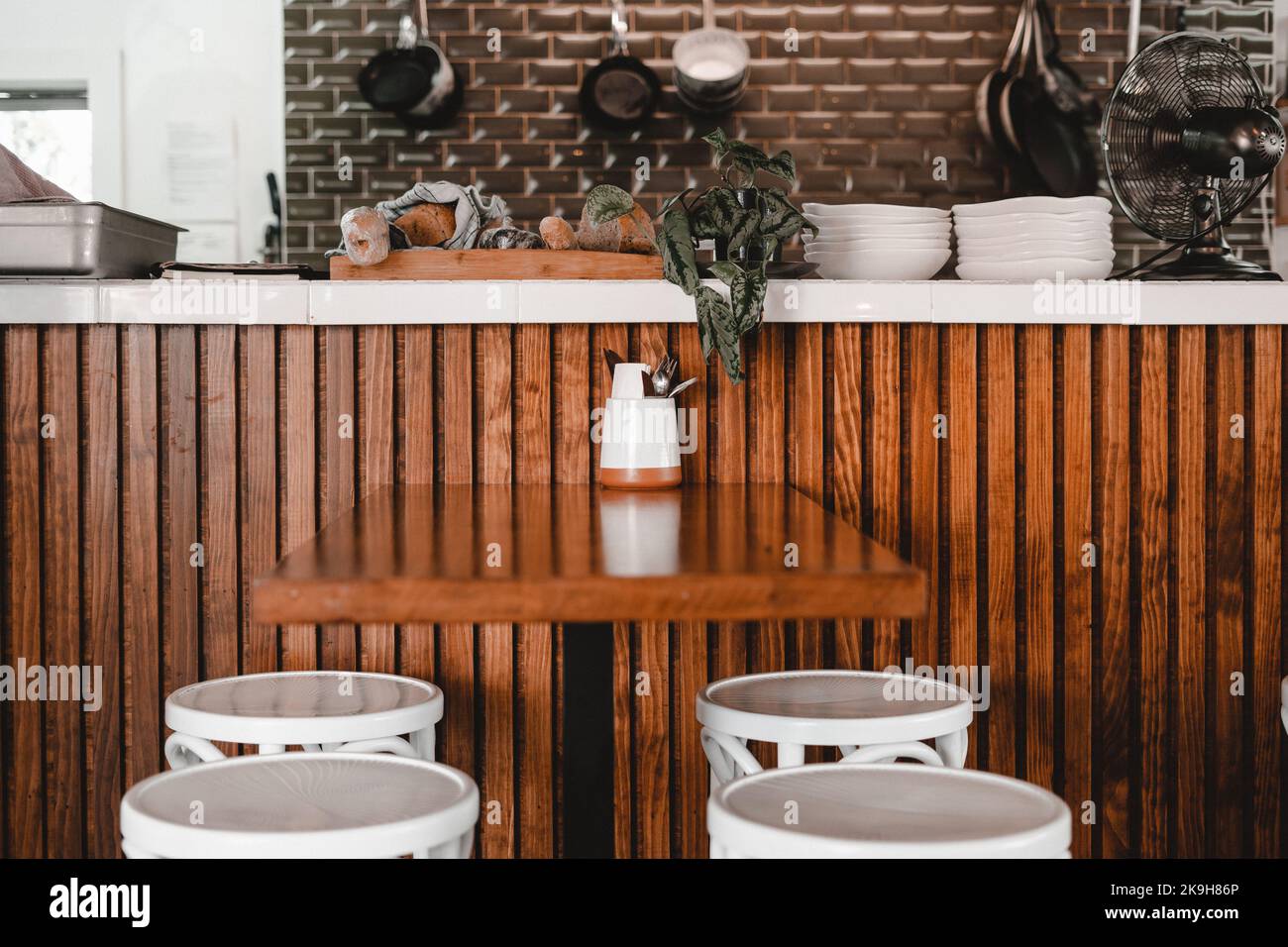 plates, kitchen utensils, table and stools in a restaurant Stock Photo
