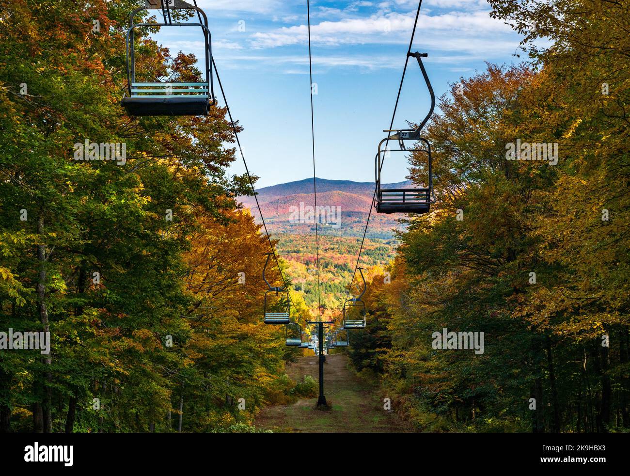 View down Mount Mansfield with ski lift chairs leading down the hillside in Vermont autumn image Stock Photo