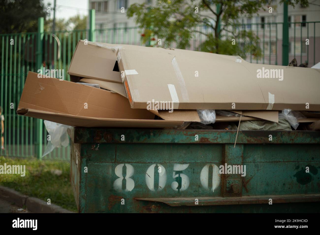 Cardboard in dumpster. Garbage can outside. Discarded cardboard. Infrastructure details Stock
