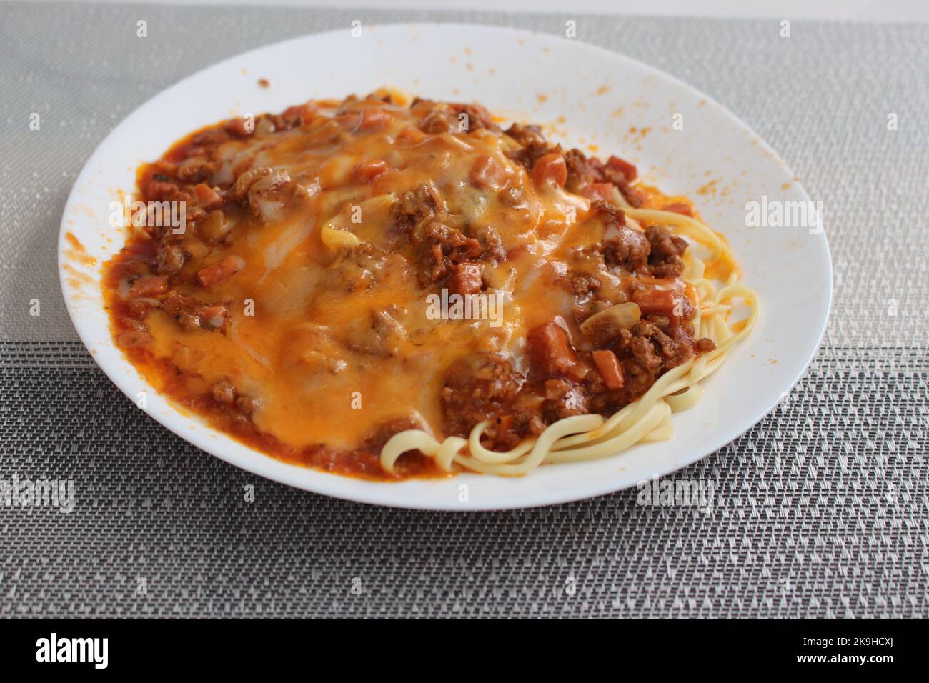 Messy plate with spaghetti full of sauce Stock Photo - Alamy