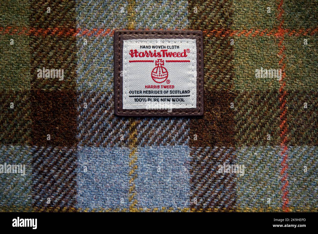 Harris Tweed label of authenticity on hand woven cloth with a tartan pattern. Stock Photo