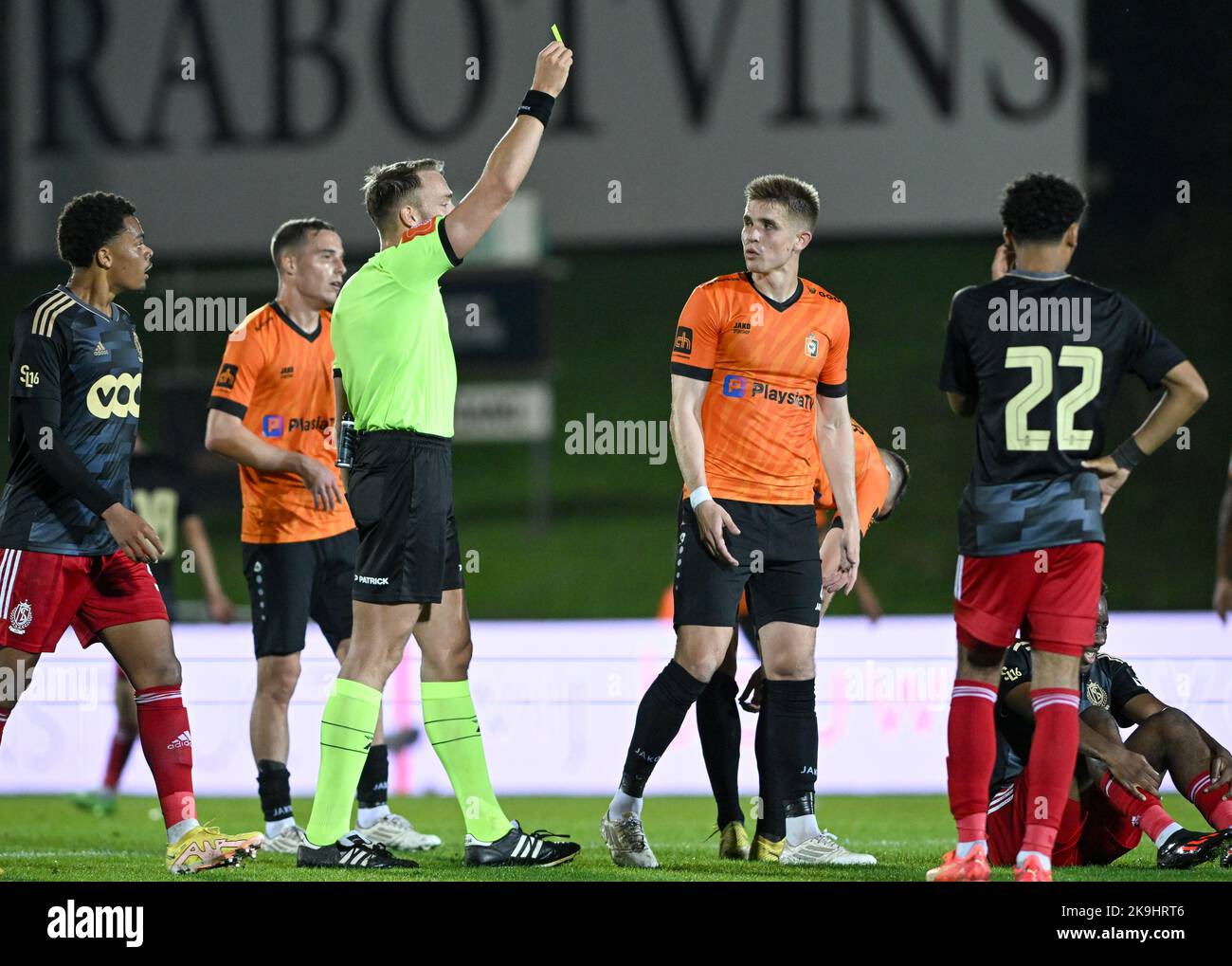 Liam Scott Fraser (4) of Deinze receives a yellow card from referee Tom