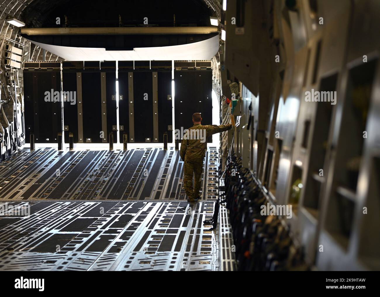 A U.S. Airman with the 62d Airlift Wing opens the ramp of a C-17 ...