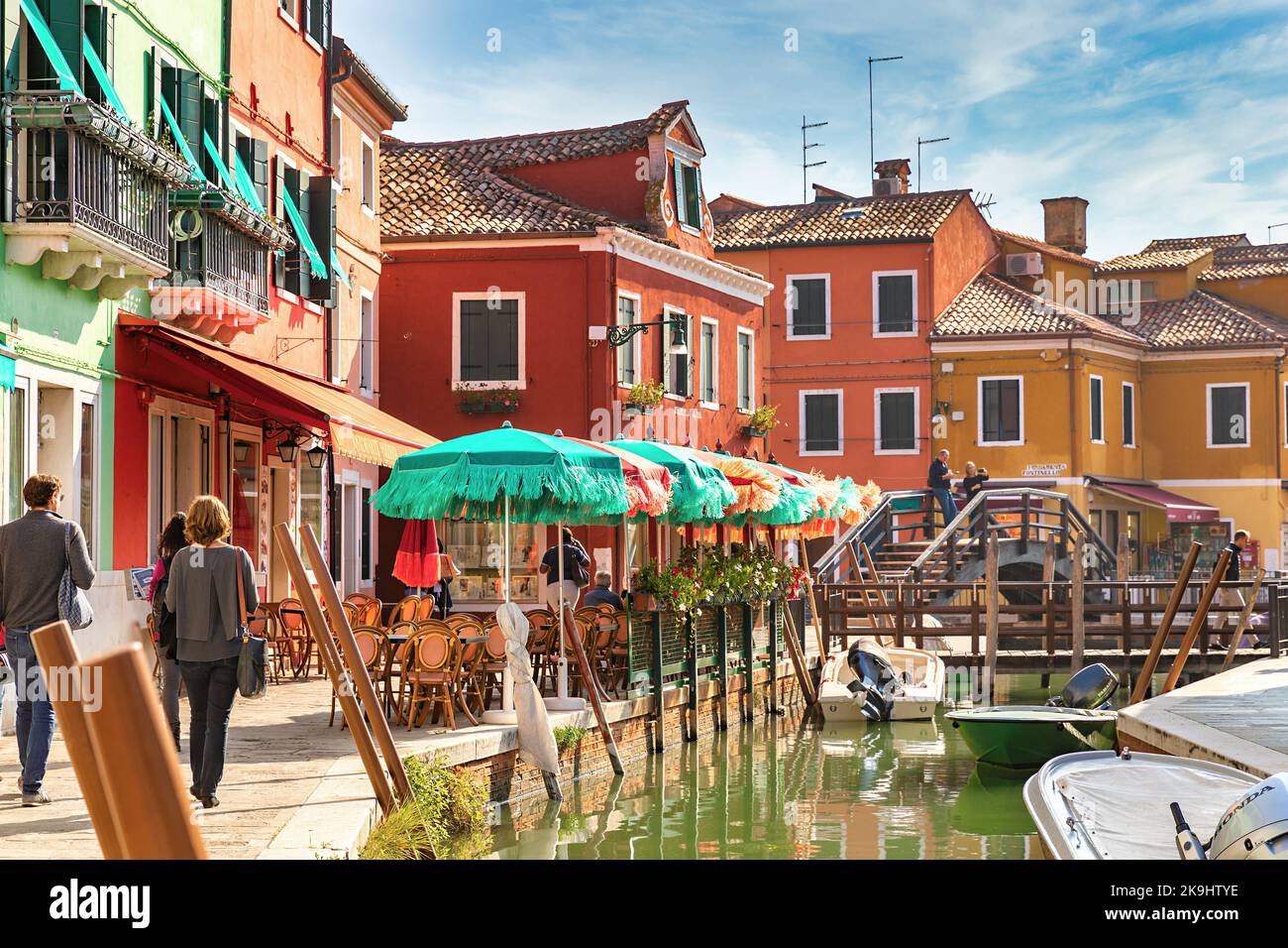 The colorful buildings, bridges, canal, umbrellas, boats on Burano Island in Venice, Italy Stock Photo