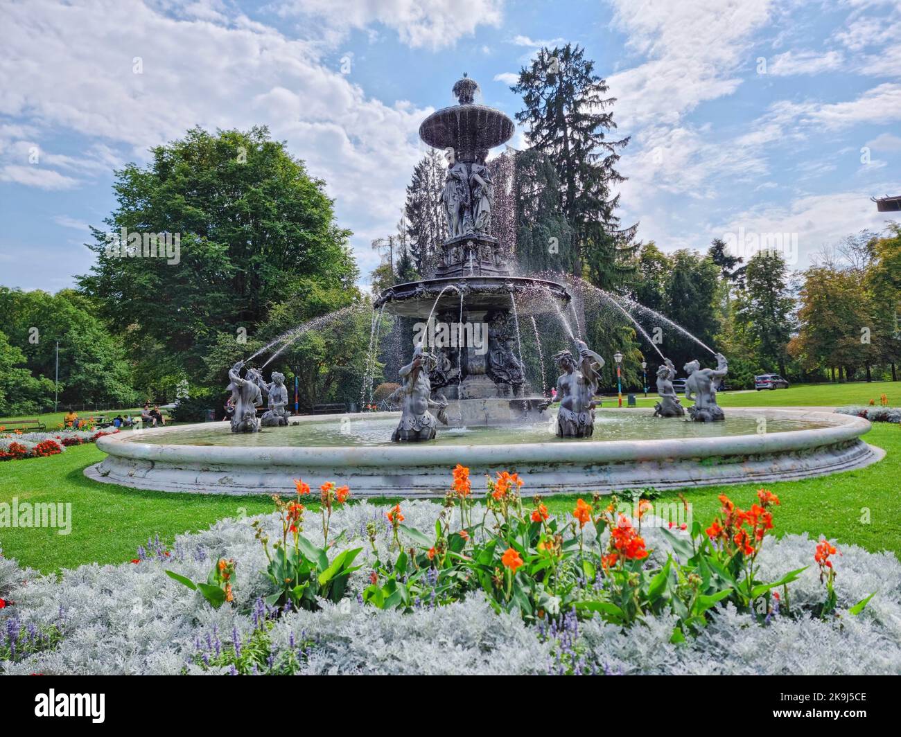 Beautiful fountain in the city park Stadtpark, a green island in the middle of the city center of Graz, Styria region, Austria. Selective focus Stock Photo