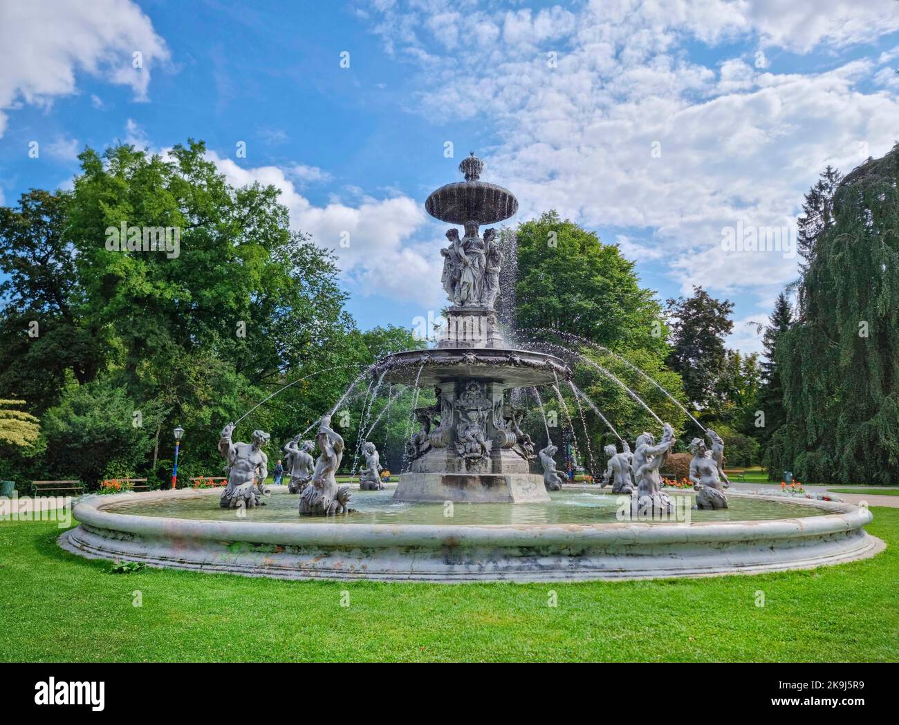 Beautiful fountain in the city park Stadtpark, a green island in the middle of the city center of Graz, Styria region, Austria. Selective focus Stock Photo