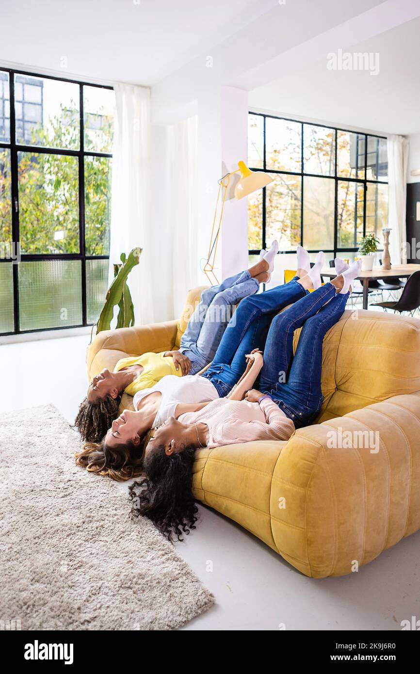 Female friendship concept with three diverse young women having fun at home Stock Photo