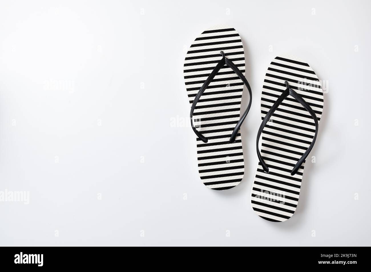 Pair of black and white stripe flip flops isolated on white background ...