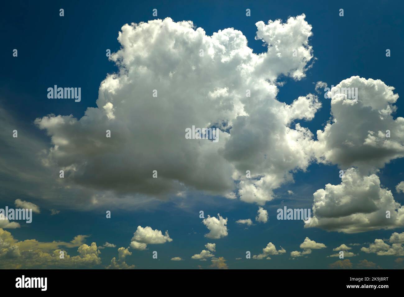 White puffy cumulus clouds on summer blue sky Stock Photo - Alamy