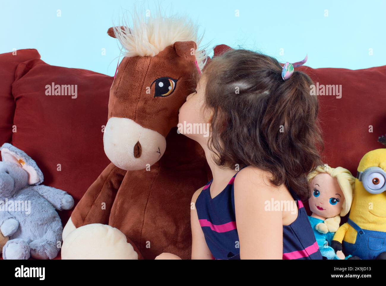 cute girl posing for a portrait with her plush toys Stock Photo - Alamy