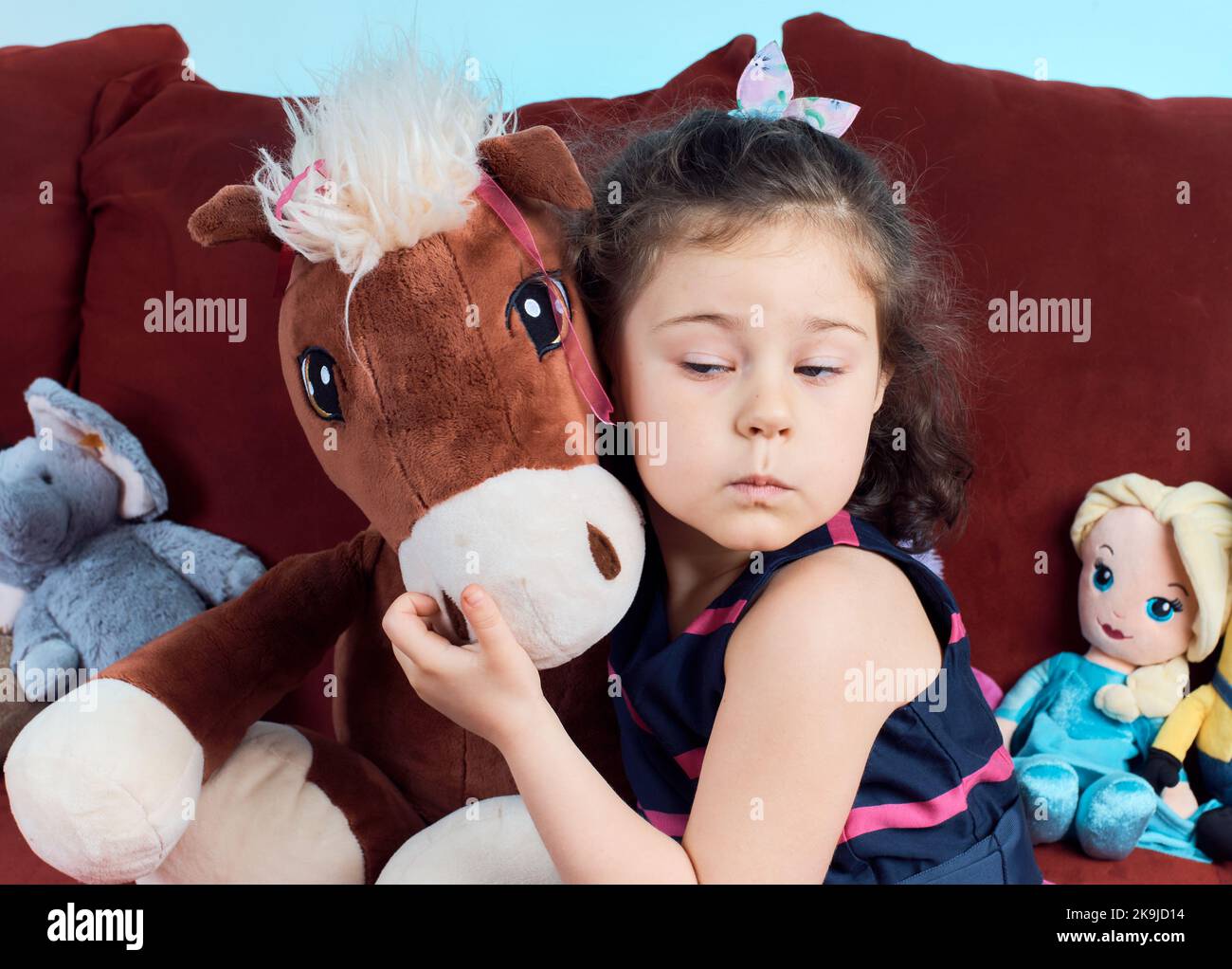 cute girl posing for a portrait with her plush toys Stock Photo - Alamy