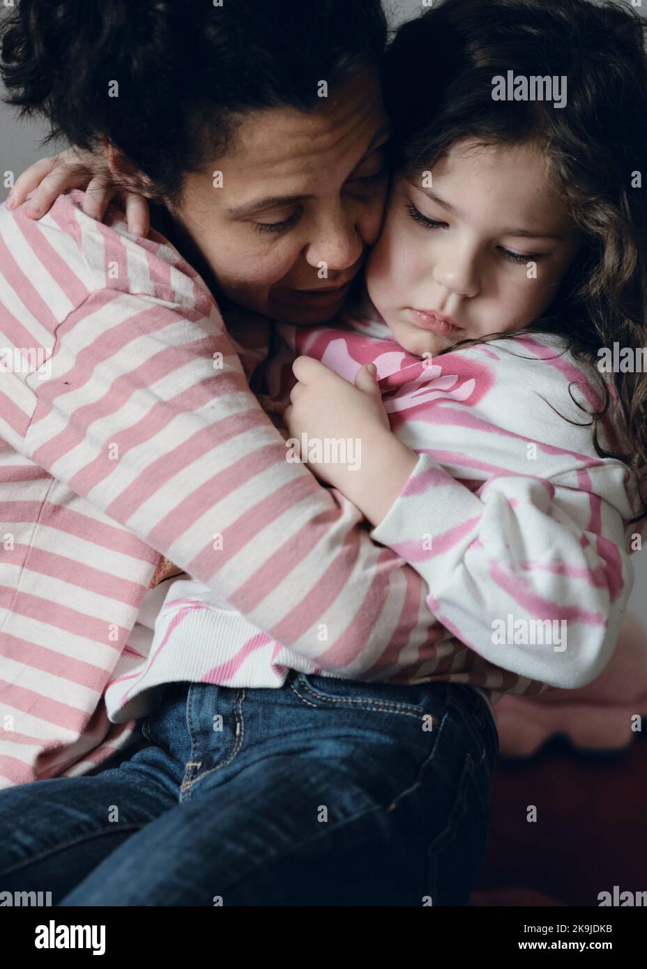 Upset little girl being consoled by mom Stock Photo - Alamy