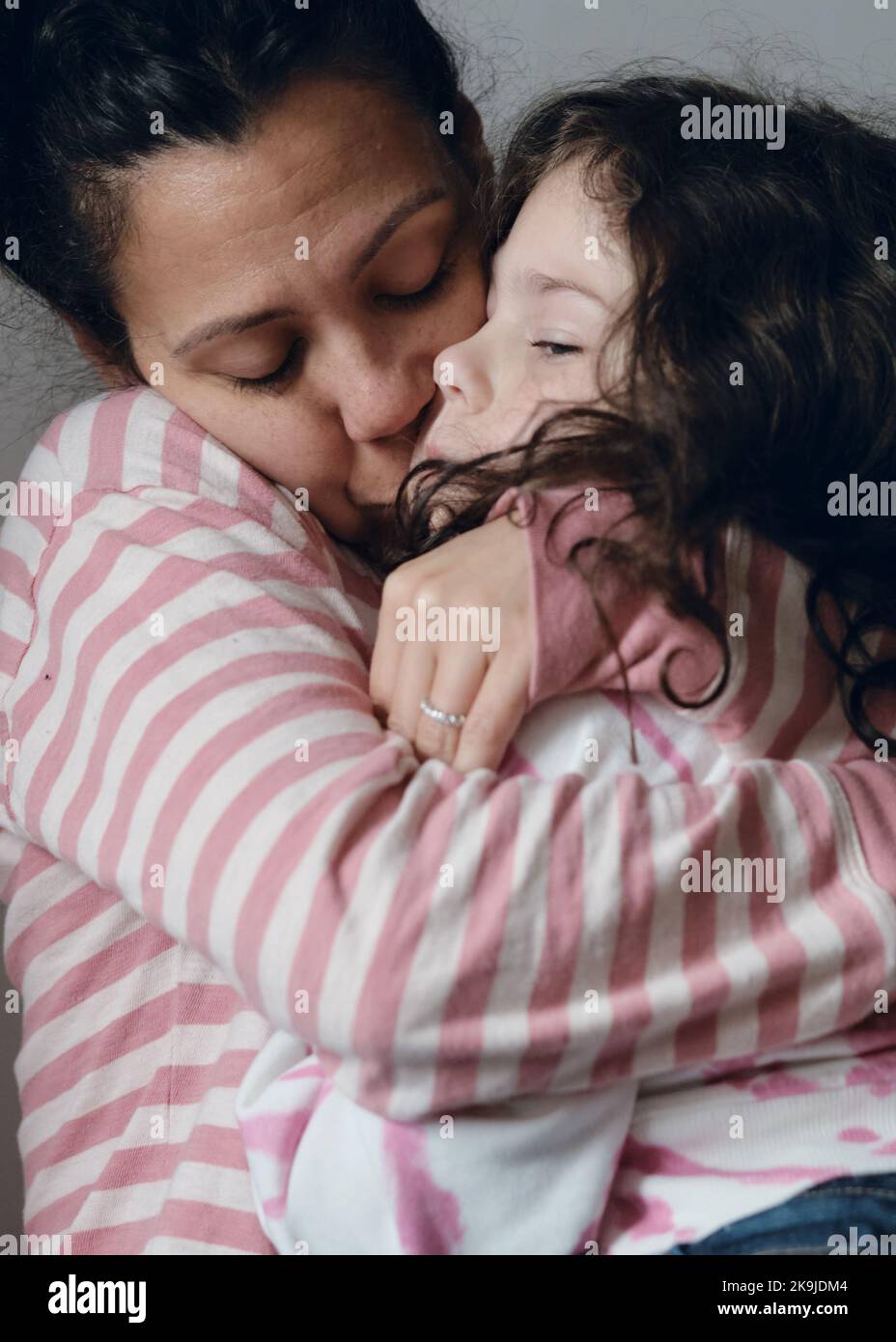 Upset little girl being consoled by mom Stock Photo - Alamy