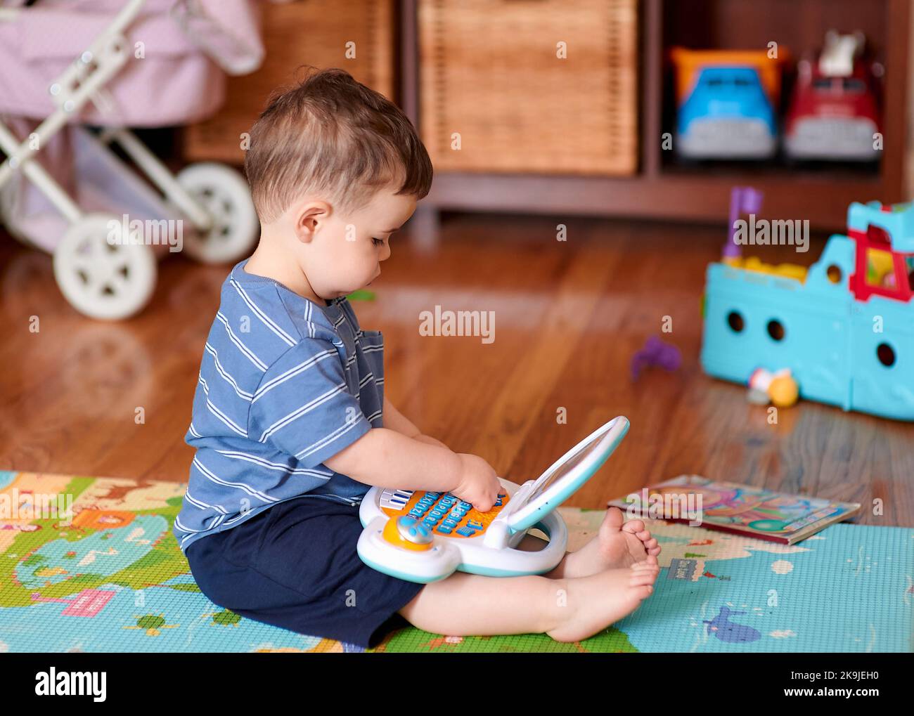 little boy playing with his toys and toy computer Stock Photo - Alamy