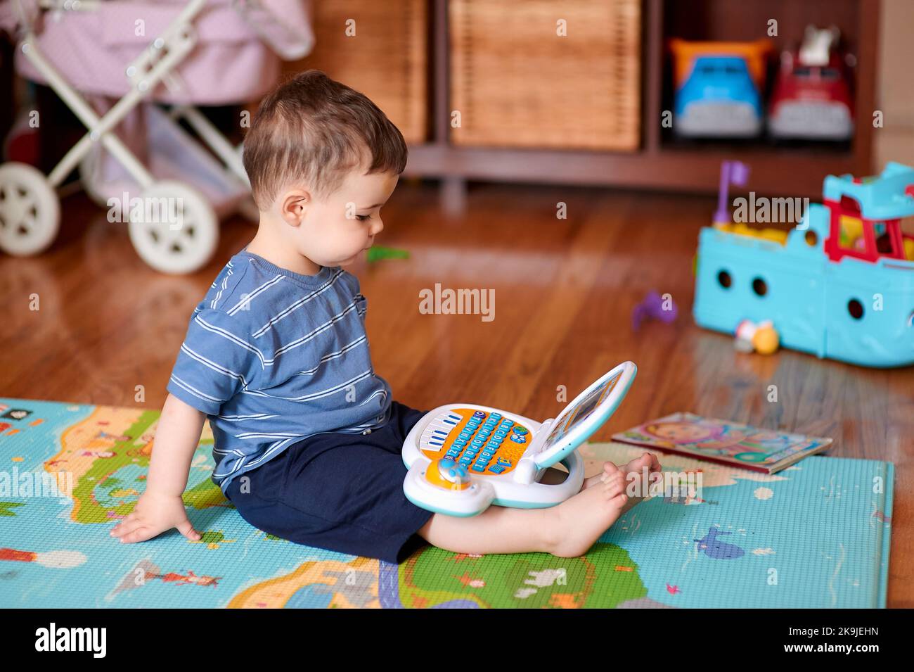 little boy playing with his toys and toy computer Stock Photo - Alamy