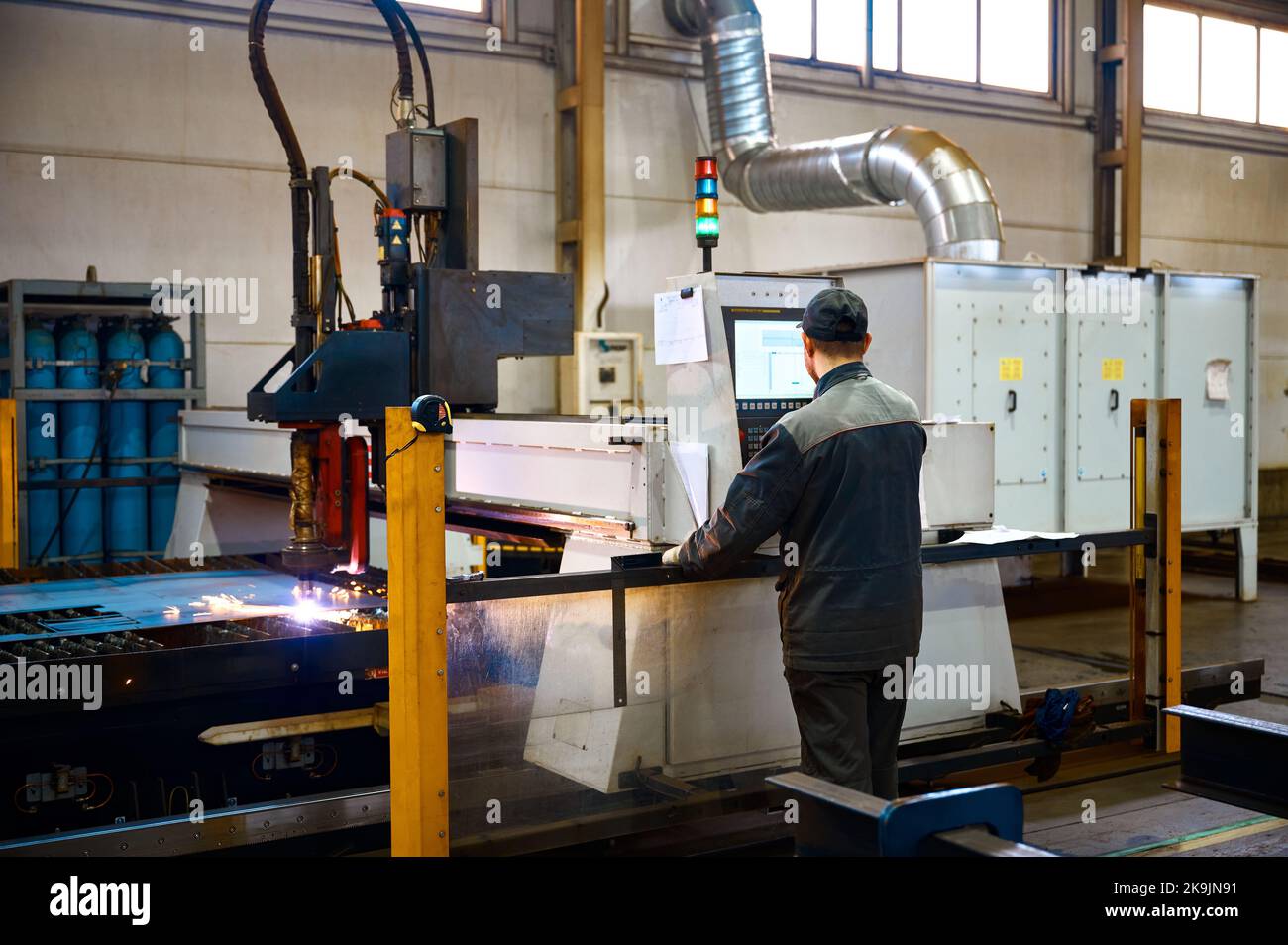 Engineer controls operation of portal plasma cutting machine Stock