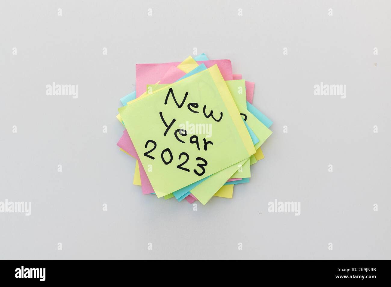 New year 2023 hand written on a yellow sticky note with isolated white background Stock Photo