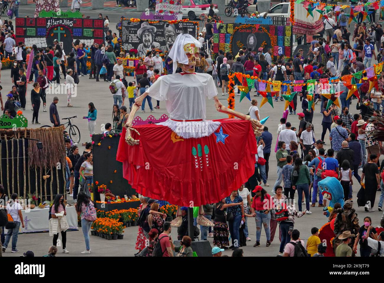 Mexico City, Mexico. 28th Oct, 2022. Crowds gather around giant sculptures of Catrina, the skeleton bride, during the Megaofrenda of Zocalo festival to celebrate the start of the Day of the Dead holiday at the Plaza de la Constitucion, October 28, 2022 in Mexico City, Mexico. Credit: Richard Ellis/Richard Ellis/Alamy Live News Stock Photo