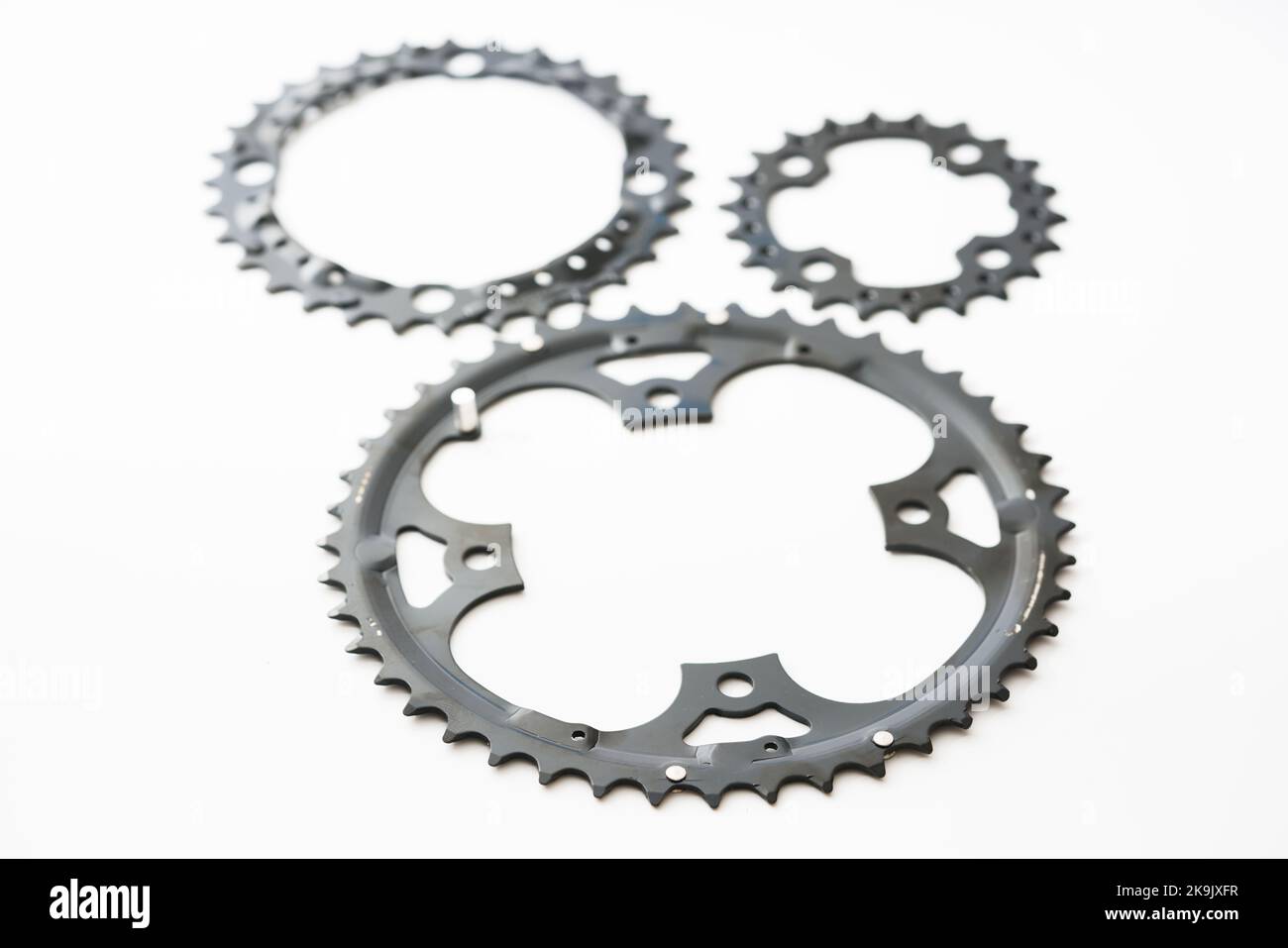 Gears, sprockets and chain of a mountain sports bike on a white