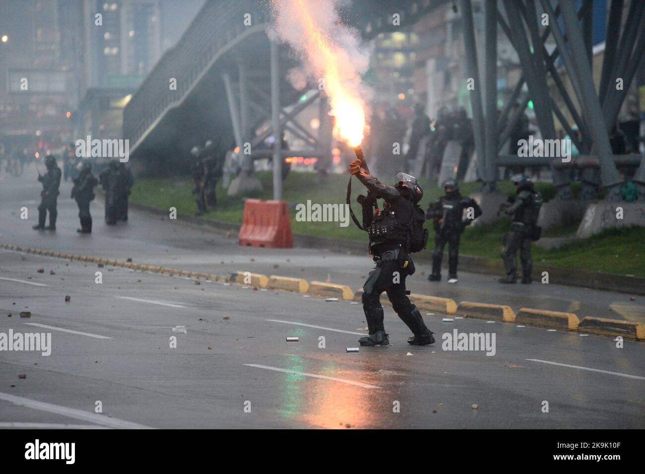 An officer from Colombia's anti-riot police squadron (UNDOMO) formerly knwon as ESMAD fires a tuffly tear gas shotgun as protests rise in Bogota, Colombia amid the liberation of political prisioners captured during the last year anti-government protests, on October 28, 2022. Photo by: Lina Gasca Martin/Long Visual Press Stock Photo
