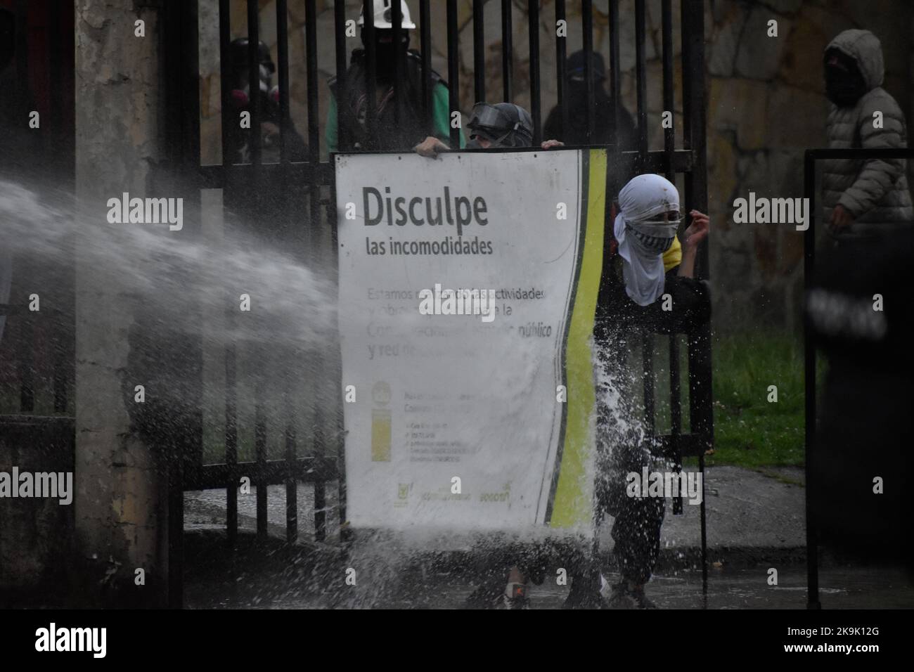 A demonstrator is hit with a water canon from a riot tank as protests raise in Bogota, Colombia amid the liberation of political prisioners captured during the last year anti-government protests, on October 28, 2022. Photo by: Cristian Bayona/Long Visual Press Stock Photo