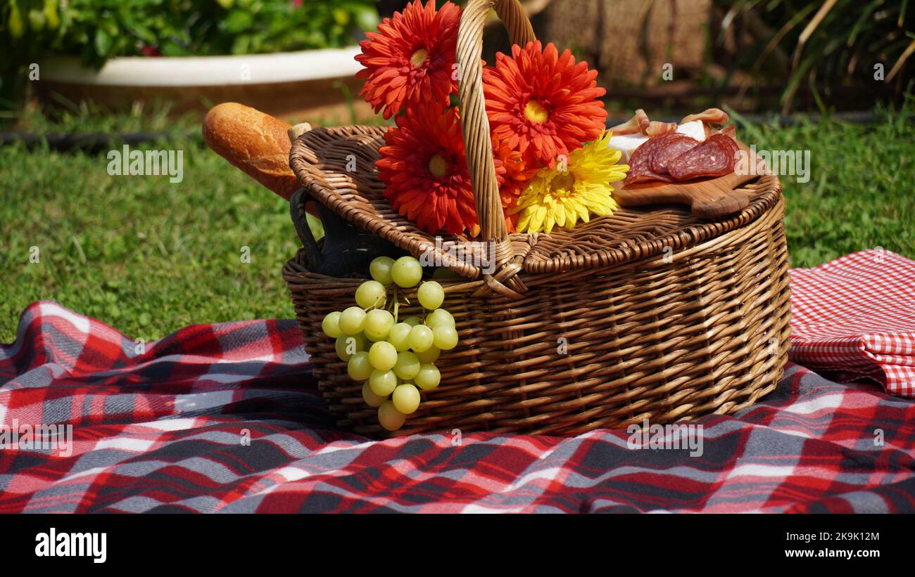 Picnic wicker basket with food and wine in the park. Summer Picnic ...