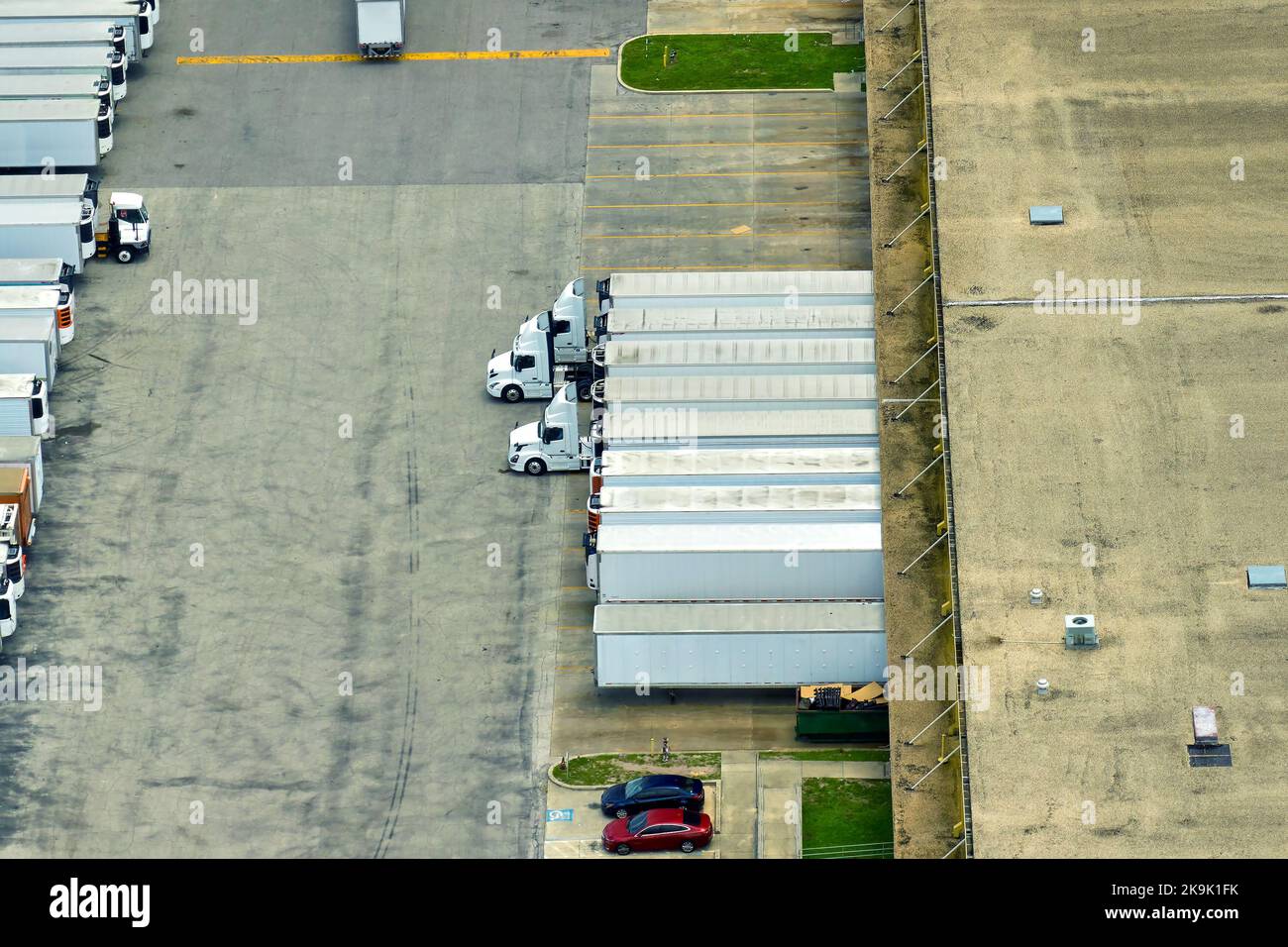 Aerial view of large commercial loading bay with many delivery trucks