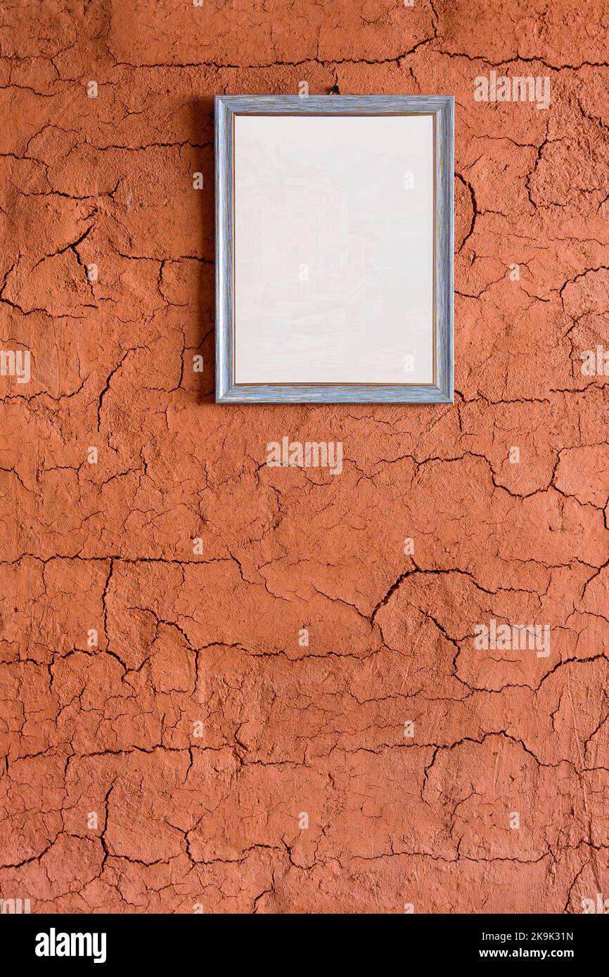 blank picture frames on soil wall of earth shelter, also called an earth house, earth bermed house is a structure usually a house with earth soil Stock Photo
