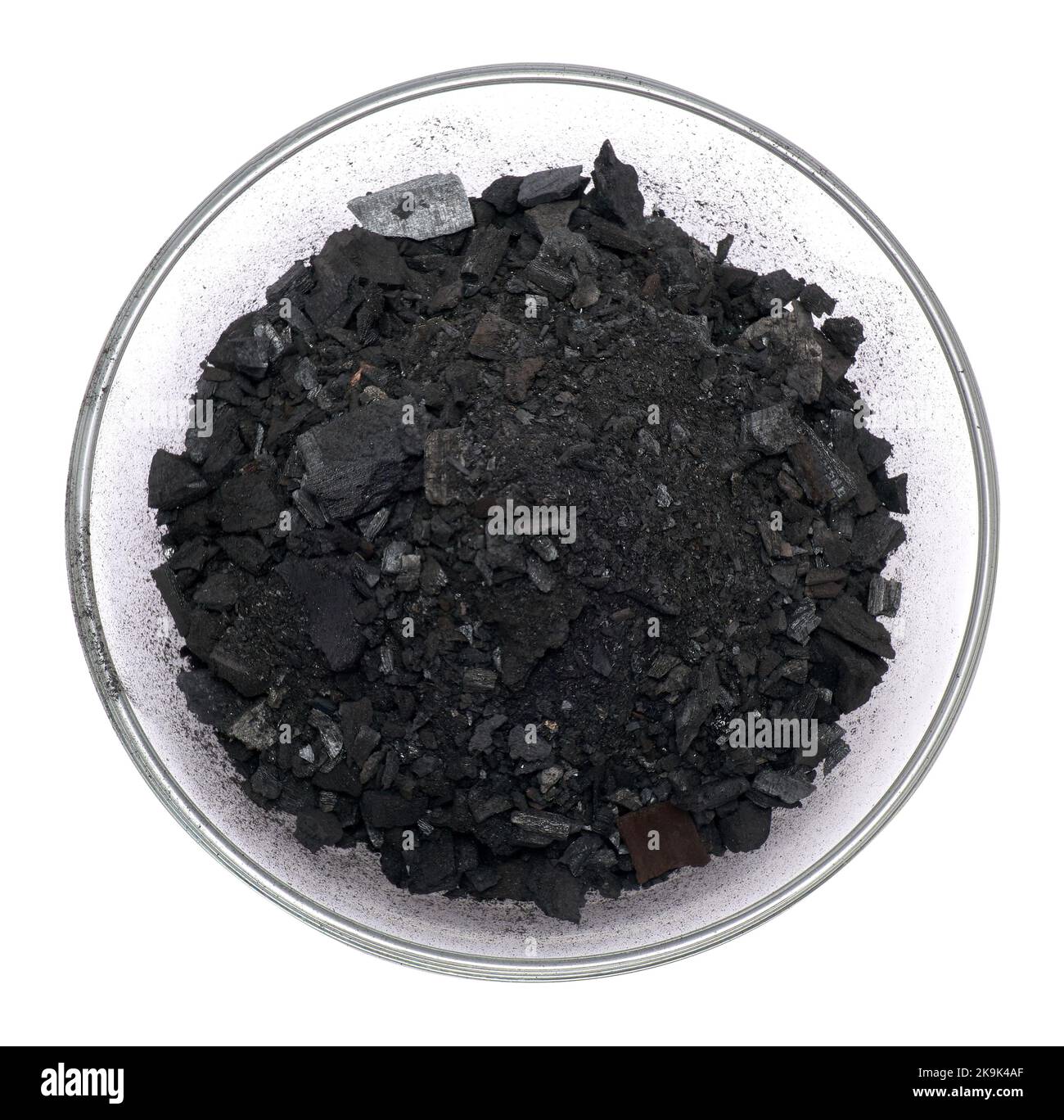 Natural wood charcoal in glass bowl for soil Isolated on white Stock