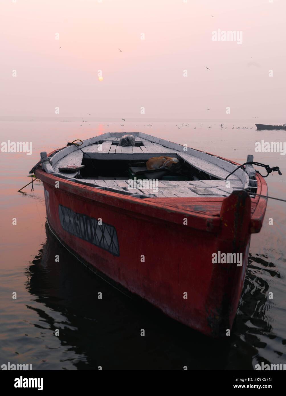 indian fishing boat in ganges river in varanasi ghat in india Stock Photo