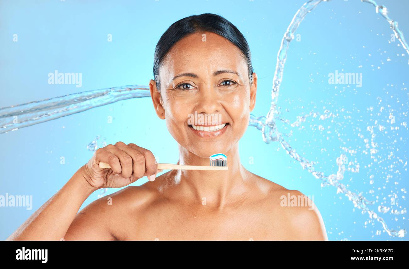 Dental, toothpaste and senior woman brushing teeth with water splash, toothbrush or self care product for enamel healthcare. Oral wellness, dental Stock Photo