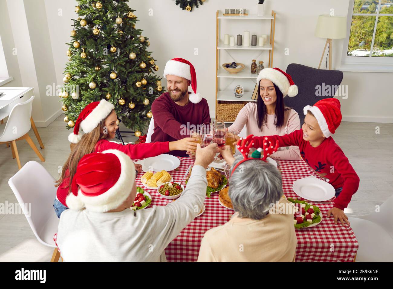 Happy family having Christmas dinner at home, enjoying meal, and