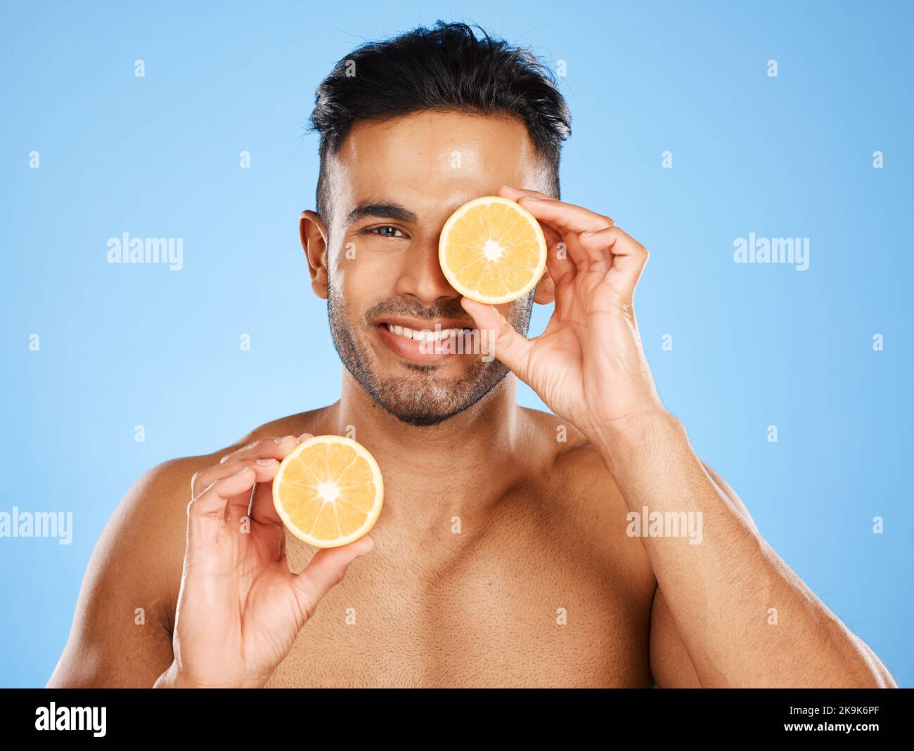Vitamin C, lemon and male skincare portrait for healthy, glowing face skin on studio background. Health, wellness and citrus treatment for smooth and Stock Photo