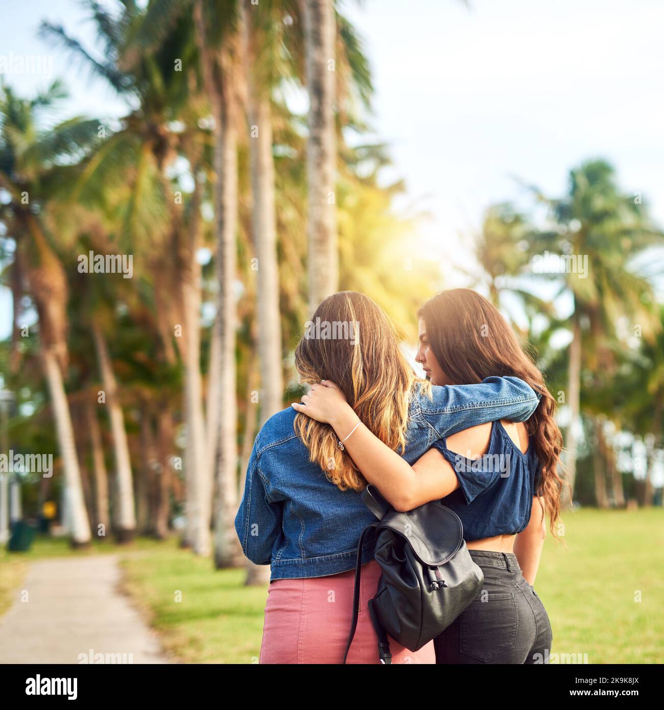 Off they go to wander together. Rearview shot of two unrecognizable female best friends hanging out in a public park. Stock Photo