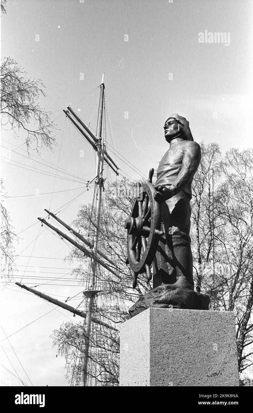 Åland trip. Statue by the seaman at rudder. The mast on the sailing ...