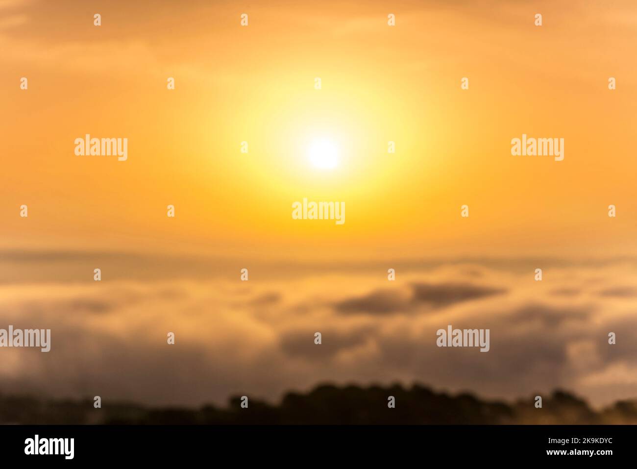 OUT OF FOCUS BACKPLATE AERIAL SUNRISE OVER SEA MIST COSTA BRAVA COAST GERONA CATALONIA SPAIN Stock Photo