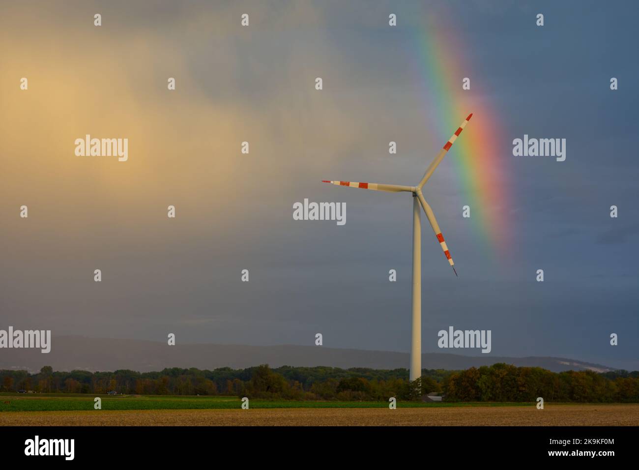 single windmill in the nature with small rainbow Stock Photo