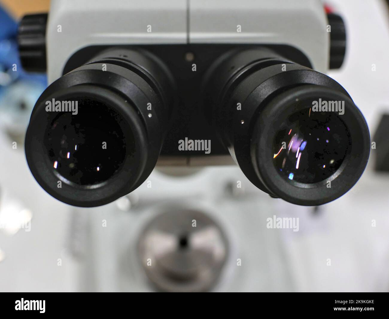 Close-up on optics of a binocular microscope, its base  is in blurred background. Stock Photo