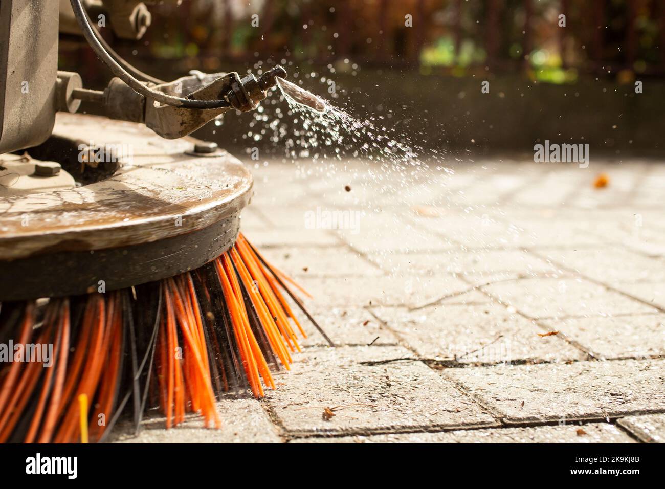 Big round brush of a street sweeper ,close up. Urban street cleaning
