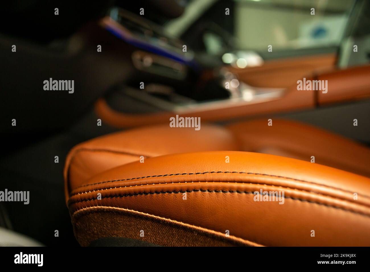 Soft focus close up of an orange leather driver's seat inside a luxury car Stock Photo