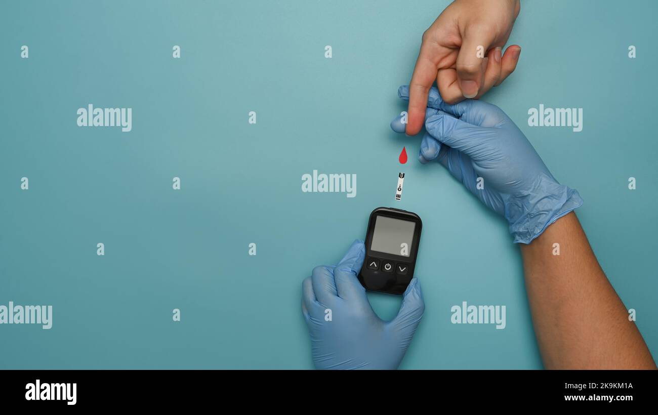 Overhead view of doctor check up blood glucose levels of diabetic woman