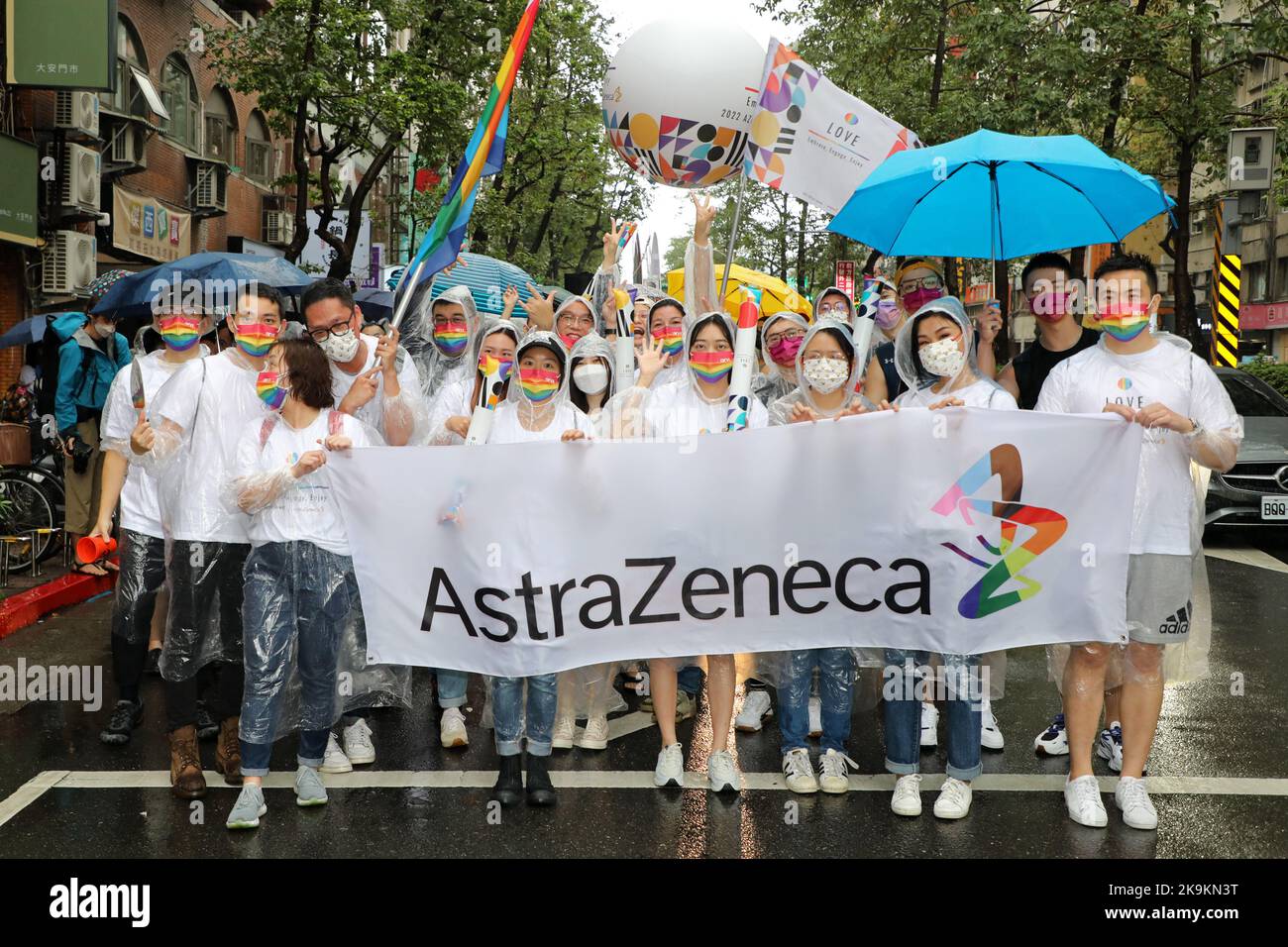 Taipei, Taiwan. 29th Oct, 2022. Participants from Astra Zeneca represent business interests in the Taipei LGBT  Pride Parade, Taipei, Taiwan. The 20th anniversary of the parade took place despite the rain and participants braved the elements mostly with umbrellas but that didn't dampen the mood or fun. Tens of thousands joined in the parade which took place in a circuitous route from Taipei City Hall in the shadow of Taiwan's tallest building, Taipei 101. Credit: Paul Brown/Alamy Live News Stock Photo
