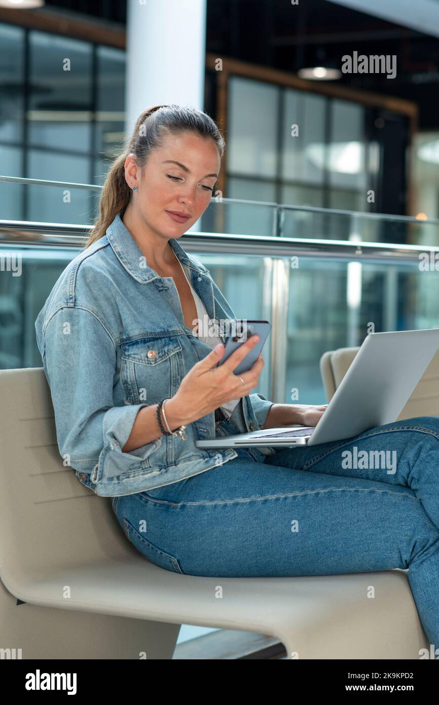 Young businesswoman working in modern office, sitting and using laptop - stock photo Stock Photo