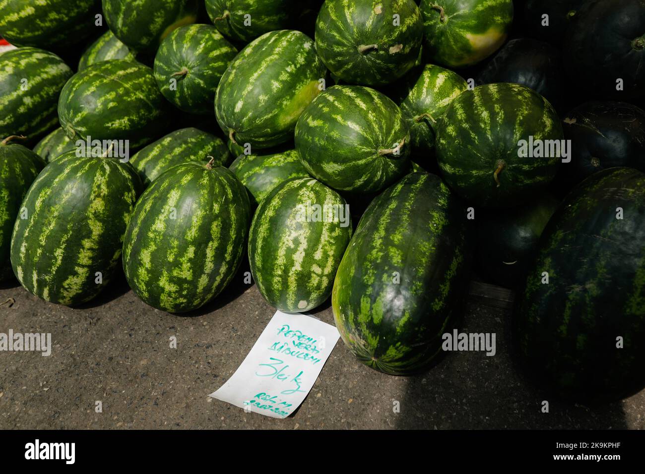 Bucharest, Romania - August 4, 2022: Shallow depth of field (selective focus) details with red watermelons for sale in a stand in Obor market in Bucha Stock Photo