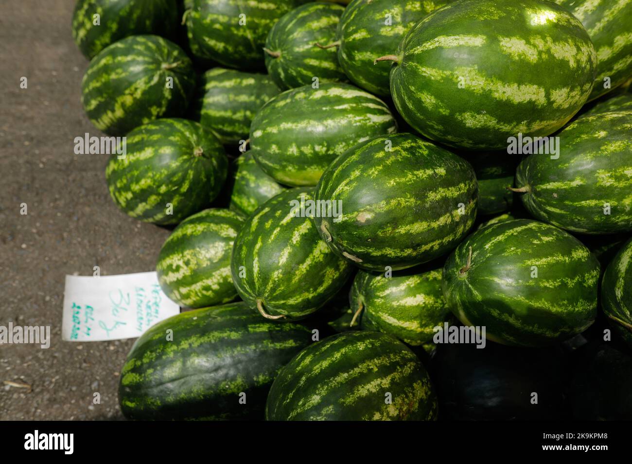Bucharest, Romania - August 4, 2022: Shallow depth of field (selective focus) details with red watermelons for sale in a stand in Obor market in Bucha Stock Photo