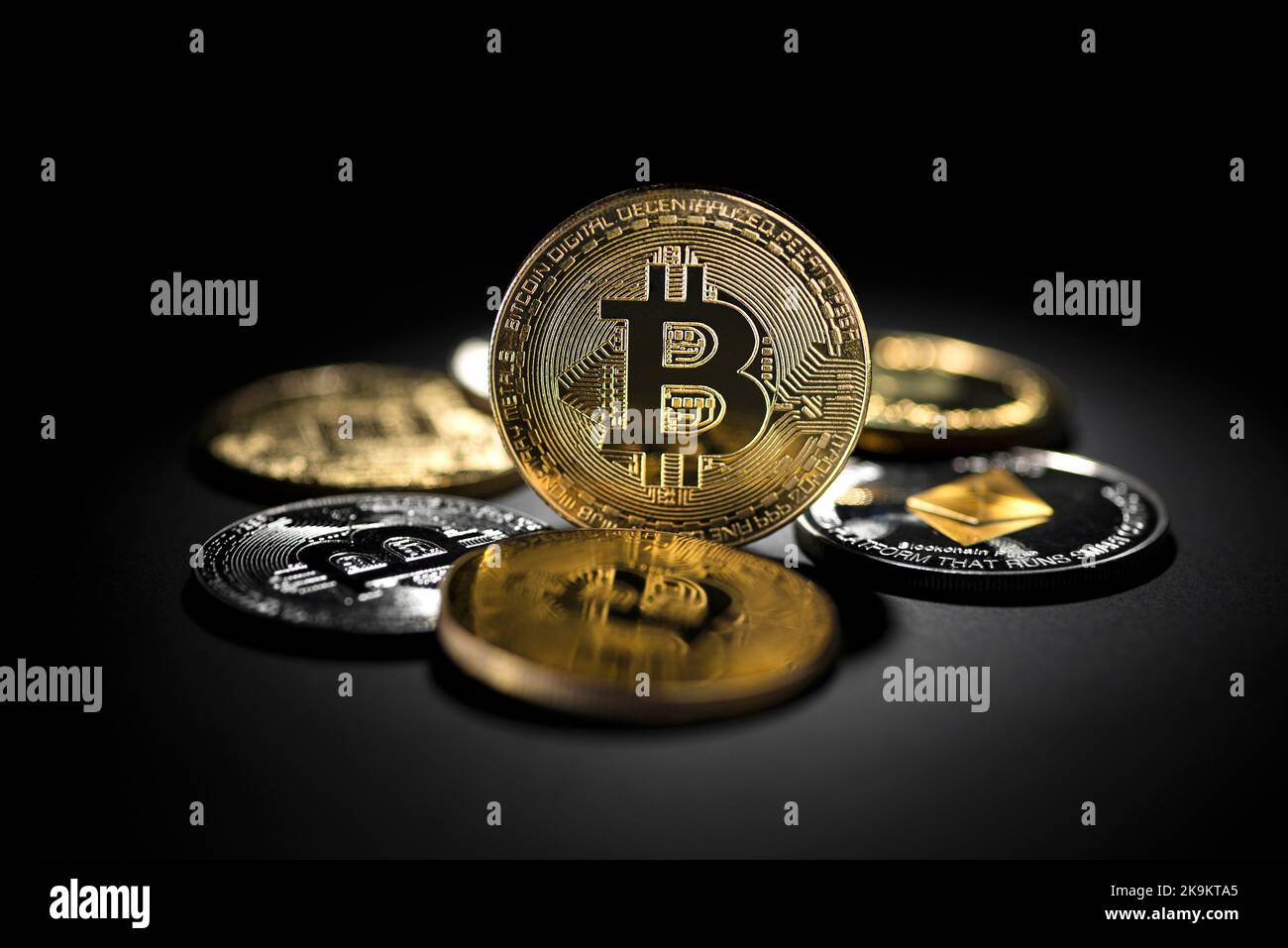 Bitcoin coins and altcoins in black background. Virtual cryptocurrency concept. Stock Photo